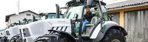 Photos of a very large tractor with a woman at the wheel